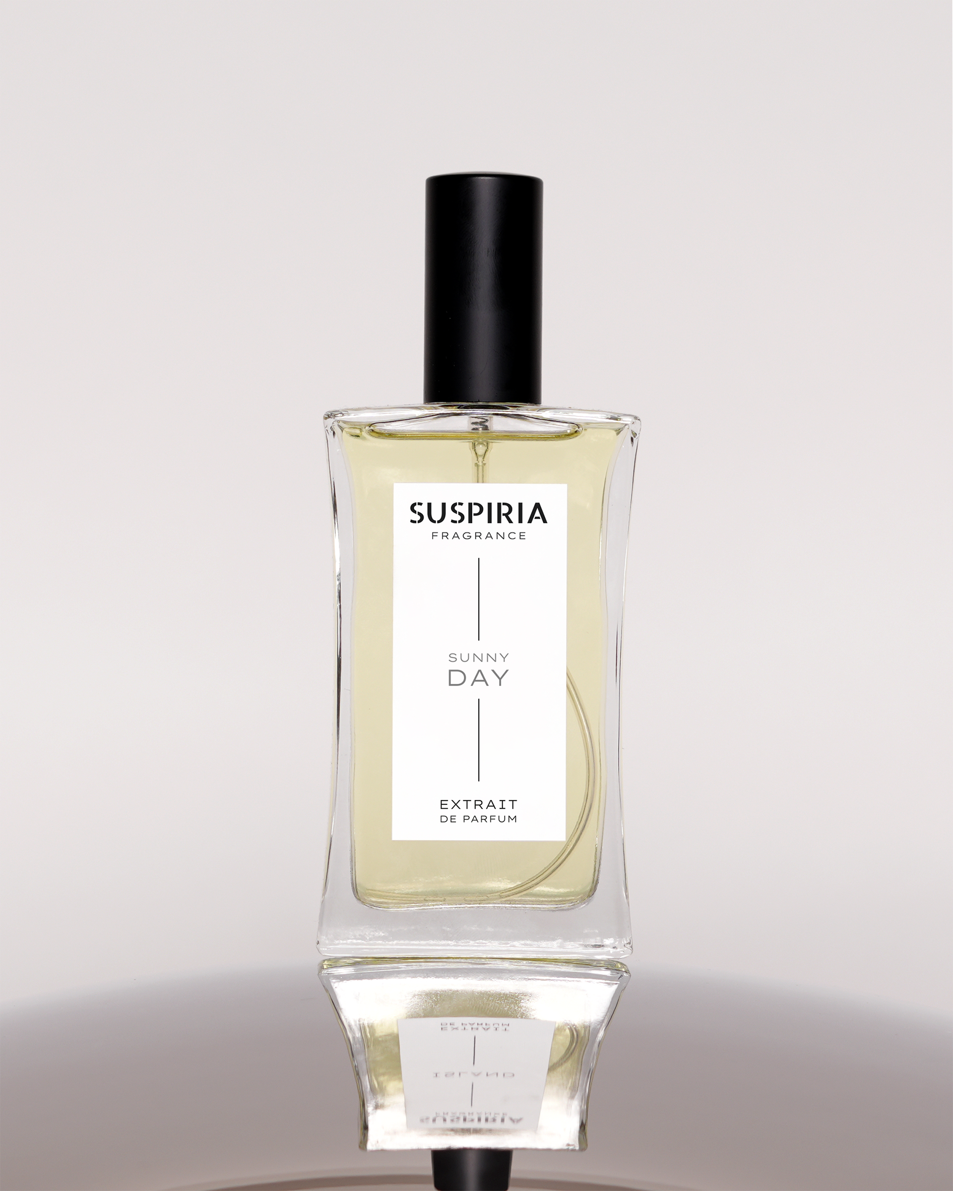 Perfume bottle labeled 'Suspiria' on a light gray background